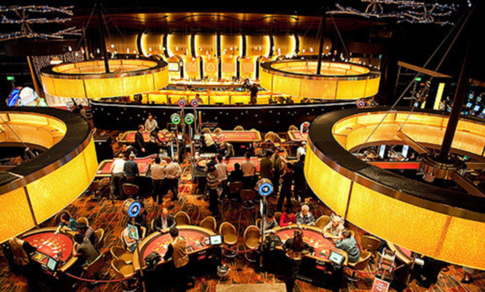 casino with players and dealers at the tables